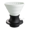 A white ceramic V60 immersion dripper with a black base, designed for coffee brewing.